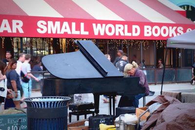 Rear view of young woman looking away while sitting on table