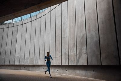 Full length of man standing against building