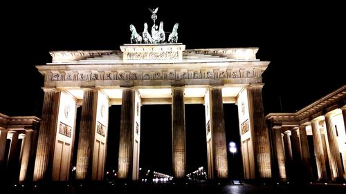 Low angle view of historical building at night