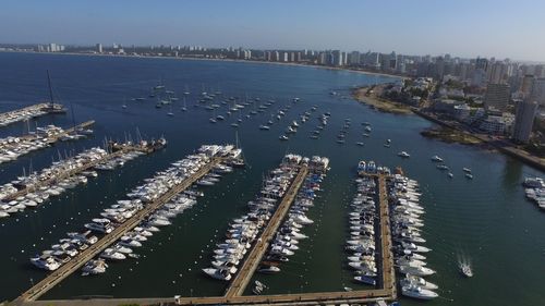 High angle view of buildings by sea against sky