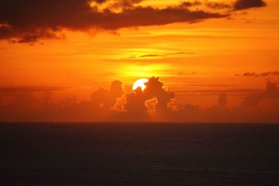 Scenic view of sea against orange sky