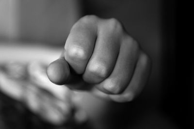 Cropped image of person showing fist