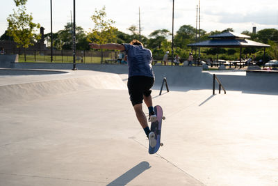 Full length rear view of man jumping