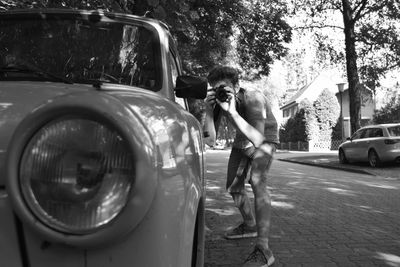 Man holding umbrella on street in city