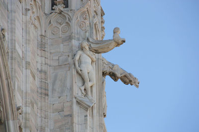 Exterior of the duomo with angel and gargoyle statue