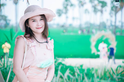 Portrait of woman wearing hat standing outdoors