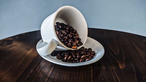 High angle view of coffee beans in bowl on table