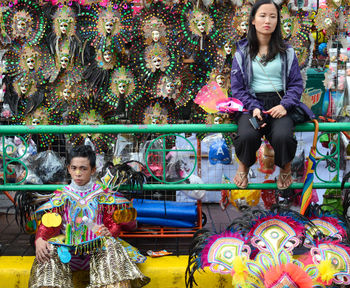 Portrait of young woman sitting outdoors