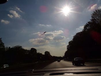 Sun shining over road