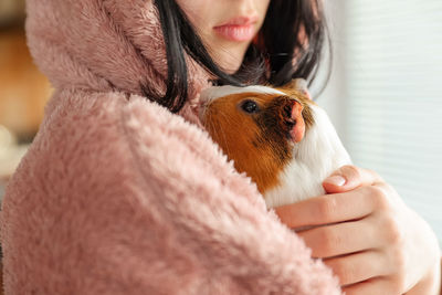 Midsection of woman with teddy bear