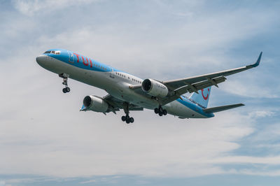 Airplane flying over sea against sky