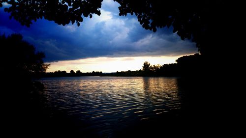 Scenic view of lake against cloudy sky