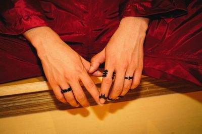 High angle view of woman hands on table