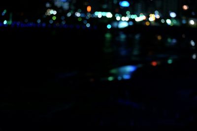 Defocused image of illuminated city at night