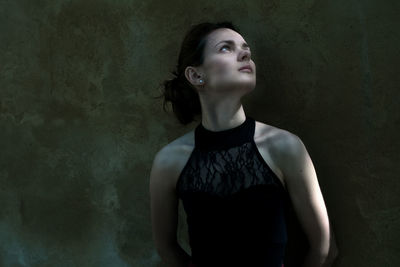 Young woman looking up