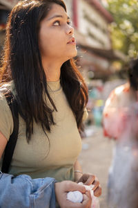 Side view of young woman looking away