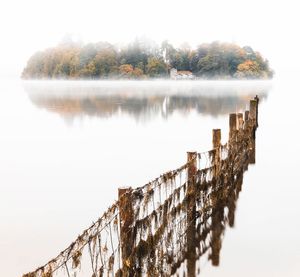 Scenic view of lake against sky during winter