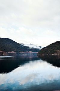 Scenic view of lake and mountains against sky