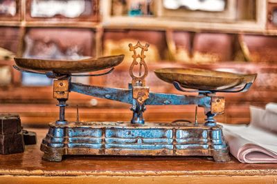 Close-up of old machinery on table