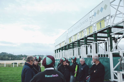 Rear view of people standing in city