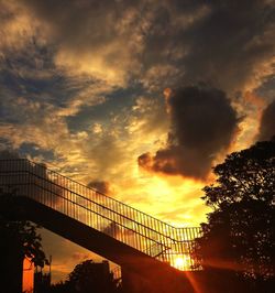Low angle view of bridge against cloudy sky