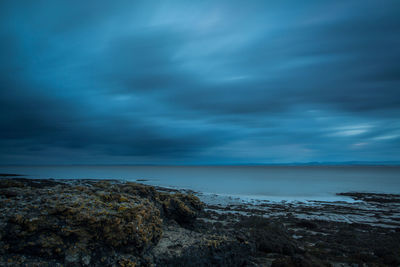 Scenic view of sea against storm clouds