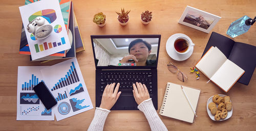 High angle view of man using laptop on table