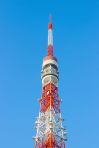 Low angle view of communications tower against blue sky