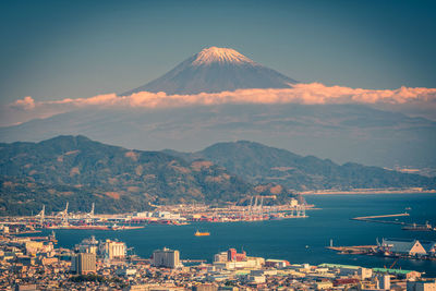 Aerial view of cityscape and mountain against sky