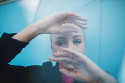 Portrait of woman holding hands