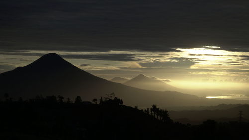 Scenic view of silhouette mountains against sky during sunset