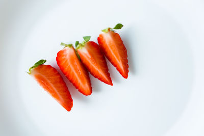 Close-up of red chili pepper against white background