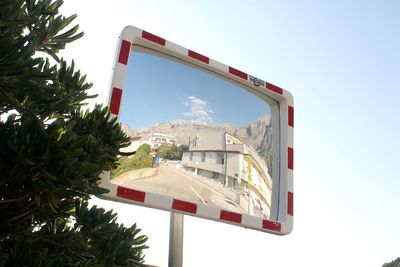 Low angle view of information sign against clear sky