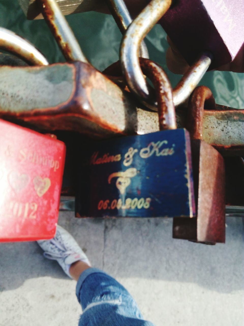 metal, padlock, lock, outdoors, text, day, close-up, one person, love lock, human body part, low section, human hand