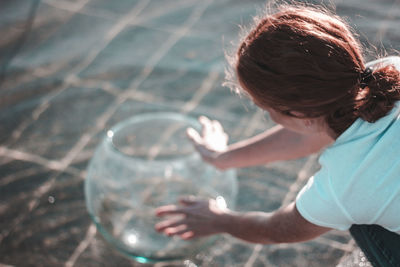 High angle view of boy holding water