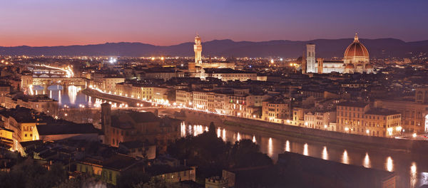 High angle view of city lit up at night