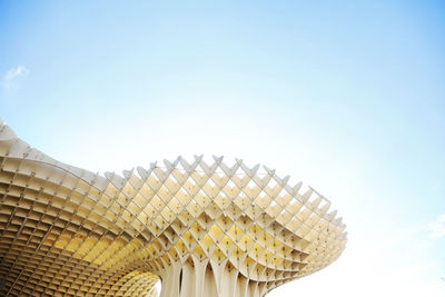 Low angle view of modern building against blue sky