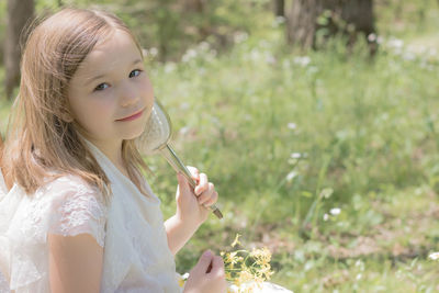 Portrait of a little girl holding a brush