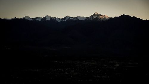 Scenic view of silhouette mountains against clear sky