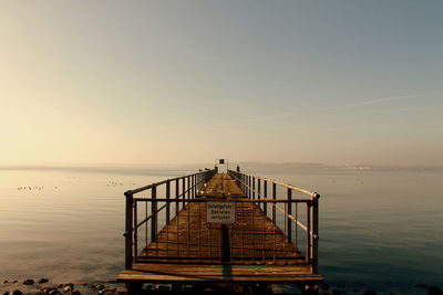 Pier over sea against clear sky