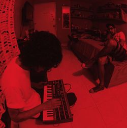 High angle view of two people in red shopping cart