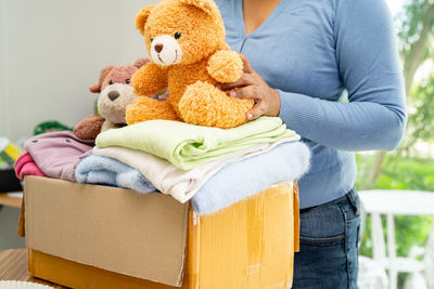 Midsection of woman with teddy bear