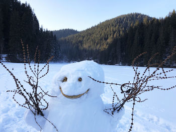 Snowman on a frozen lake