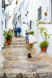 Rear view of people walking on steps