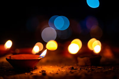 Close-up of illuminated candles against blurred background