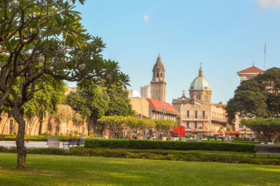 View of trees and building against sky