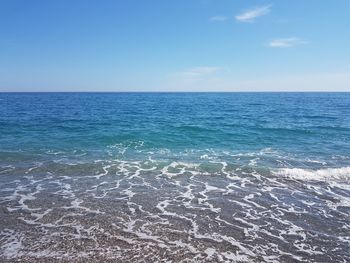 Scenic view of sea against blue sky