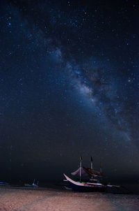 Sailboats in sea against sky at night