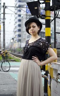 Portrait of smiling young woman standing outdoors