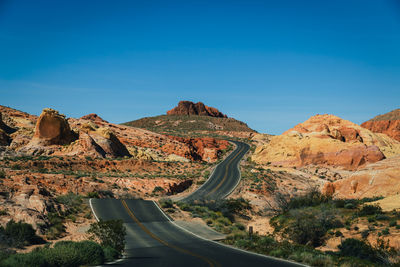 Scenic view of mountains against clear blue sky